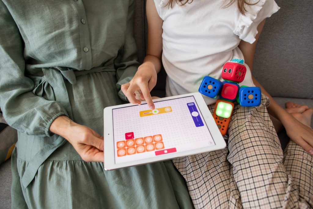 Parent and Child Playing Together on Tablet